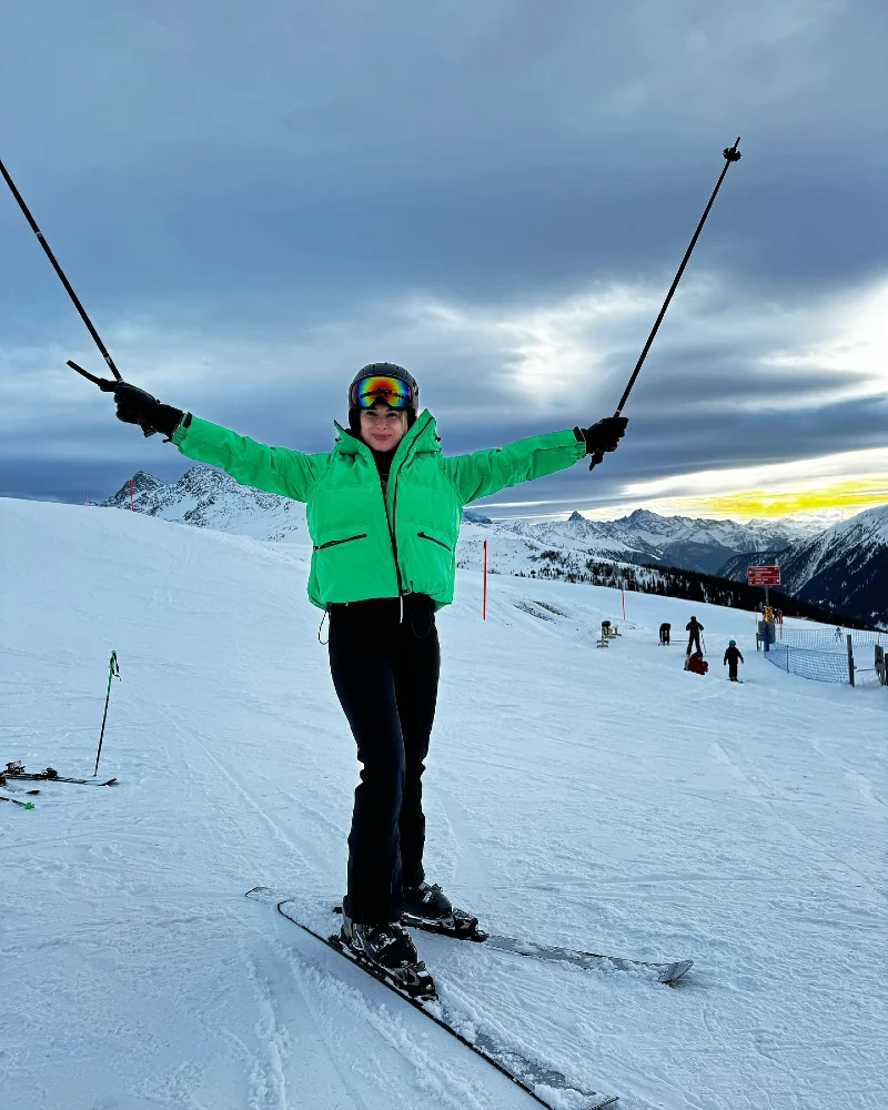 Neon Green Puffer Jacket with Black Ski Pants and Goggles
