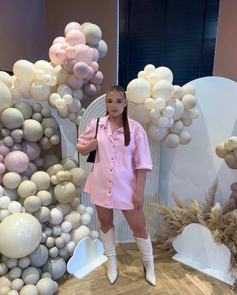 Oversized Bubblegum Pink Button-Up Dress with Slouchy Cream Western Boots and Neutral Balloon Installations