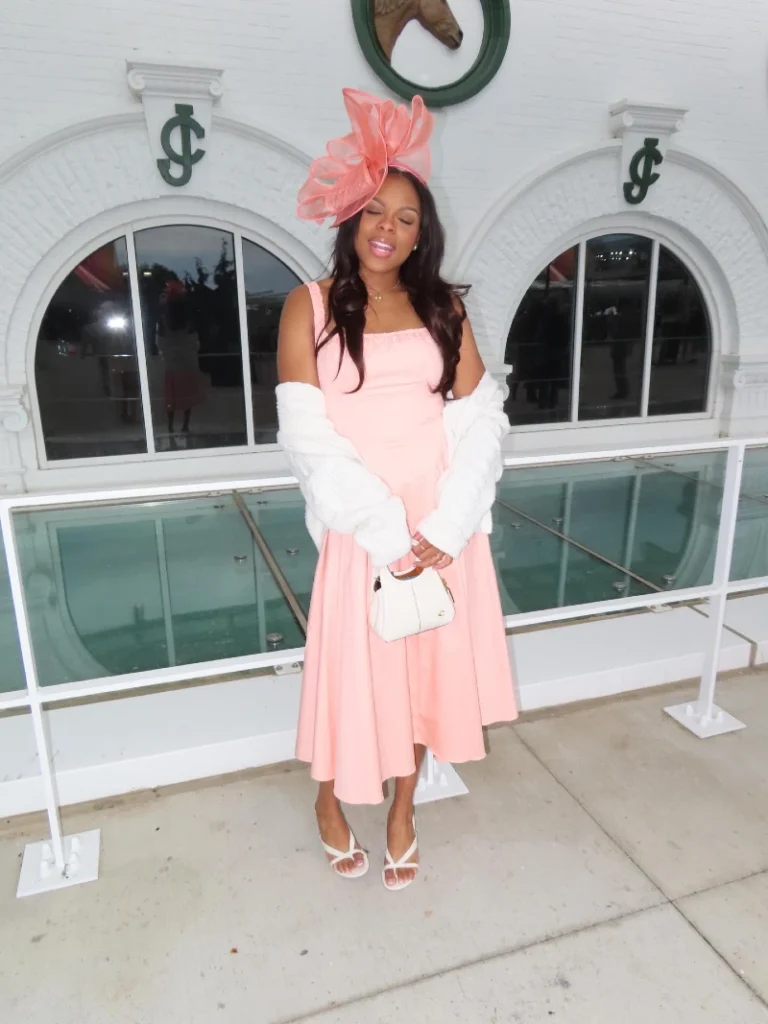 Pastel Peach Midi Dress with Chunky Knit Cardigan and Sculptural Fascinator
