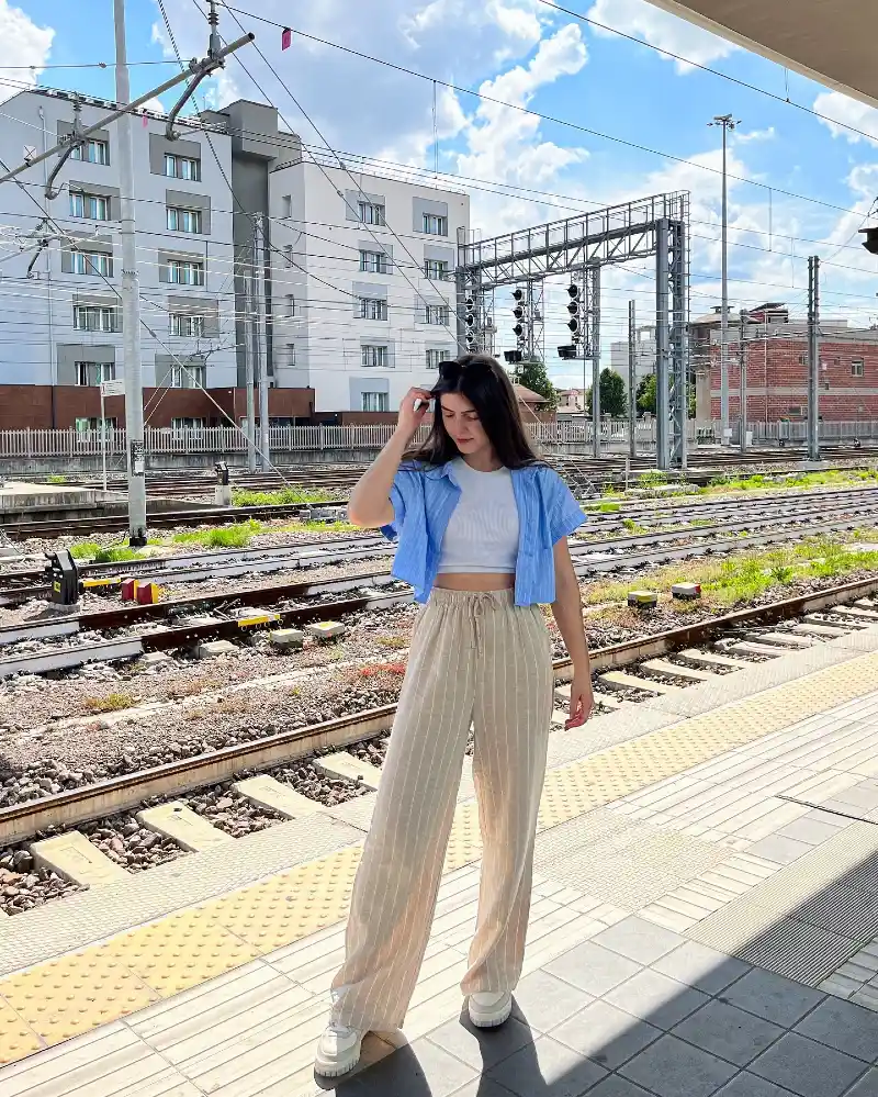 Striped Linen Trousers with Cropped Blue Button-Down Shirt and White Sneakers