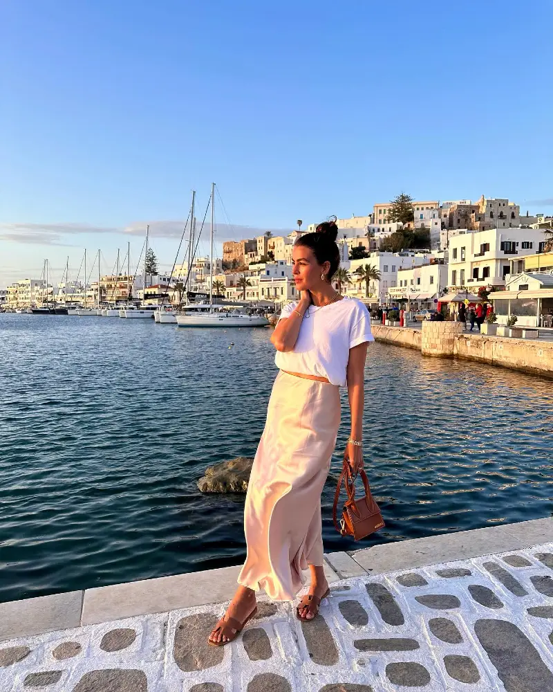 White T-Shirt with Fluid Satin Maxi Skirt, Leather Sandals, and Brown Handbag