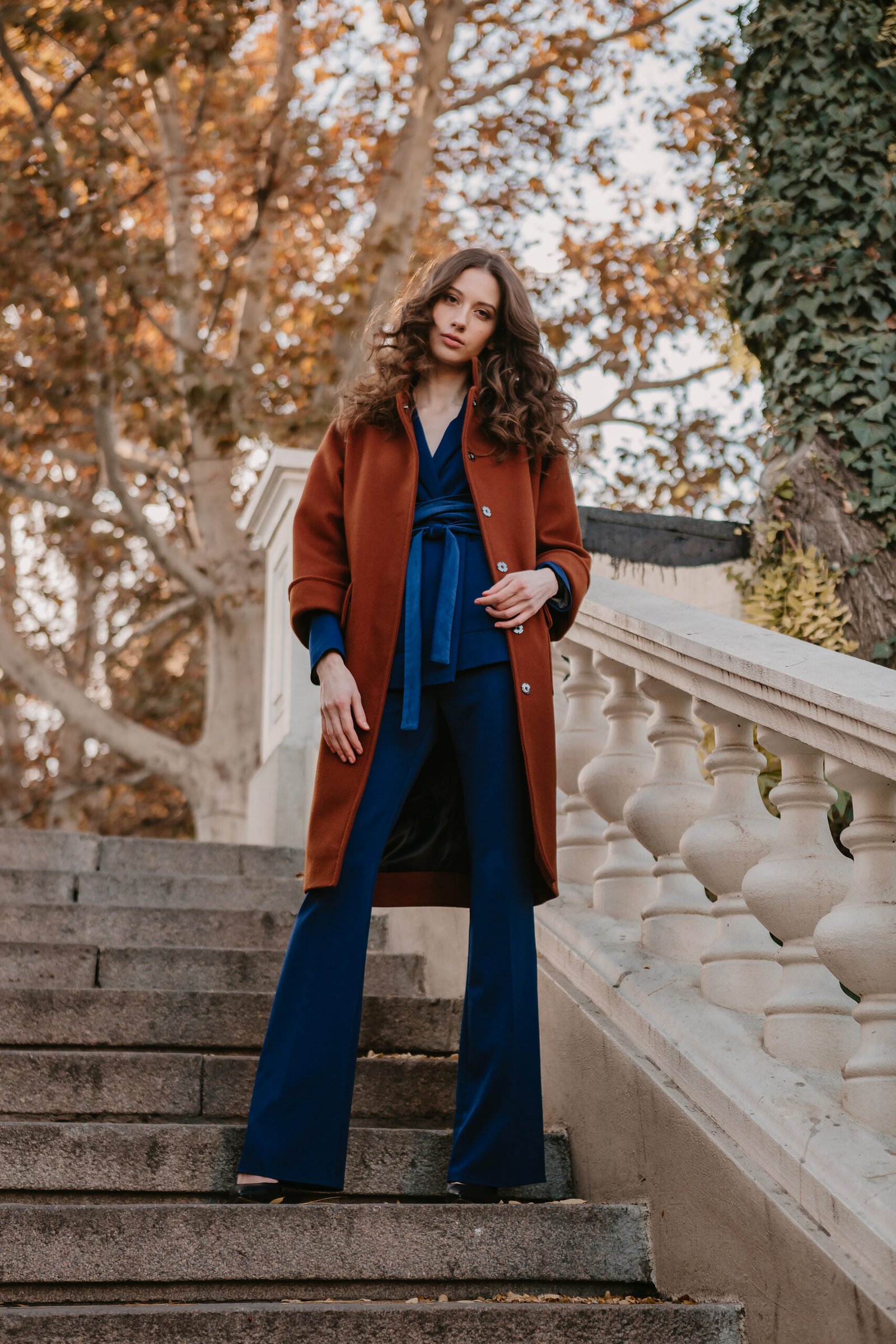 A Polished Blue Jumpsuit with a Statement Tan Coat For Stylish Educator Days