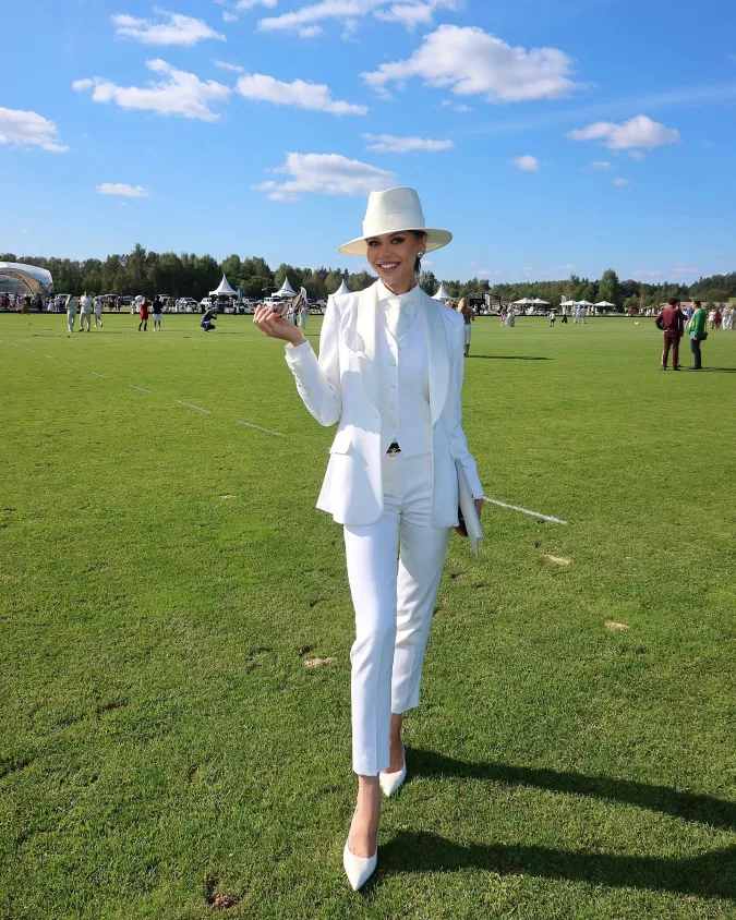 All White Tailored Suit with Wide Brim Hat on Sunlit Polo Field