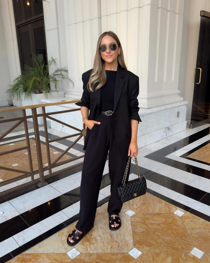 Black Blazer and Wide Leg Trousers in a Marble Lobby