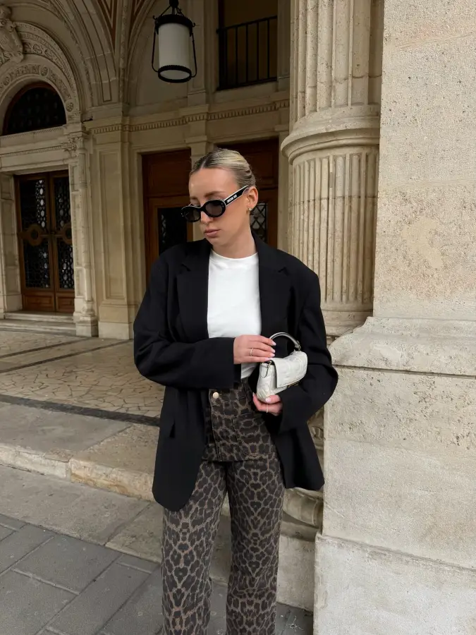 Black Blazer with White Base Top and Leopard Trousers in Ornate Stone Architecture