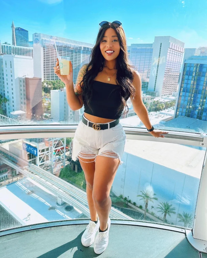 Black Crop Tank with White Distressed Shorts Above the Strip