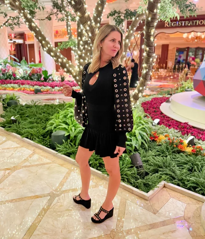 Black Eyelet Sleeve Mini Dress in a Glowing Garden Lobby