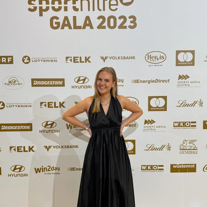 Black Halter Column Gown at Step-and-Repeat Gala Wall