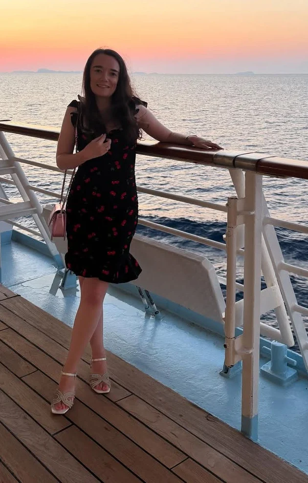 Black Mini Dress with Red Floral Print and Pink Chain Strap Bag