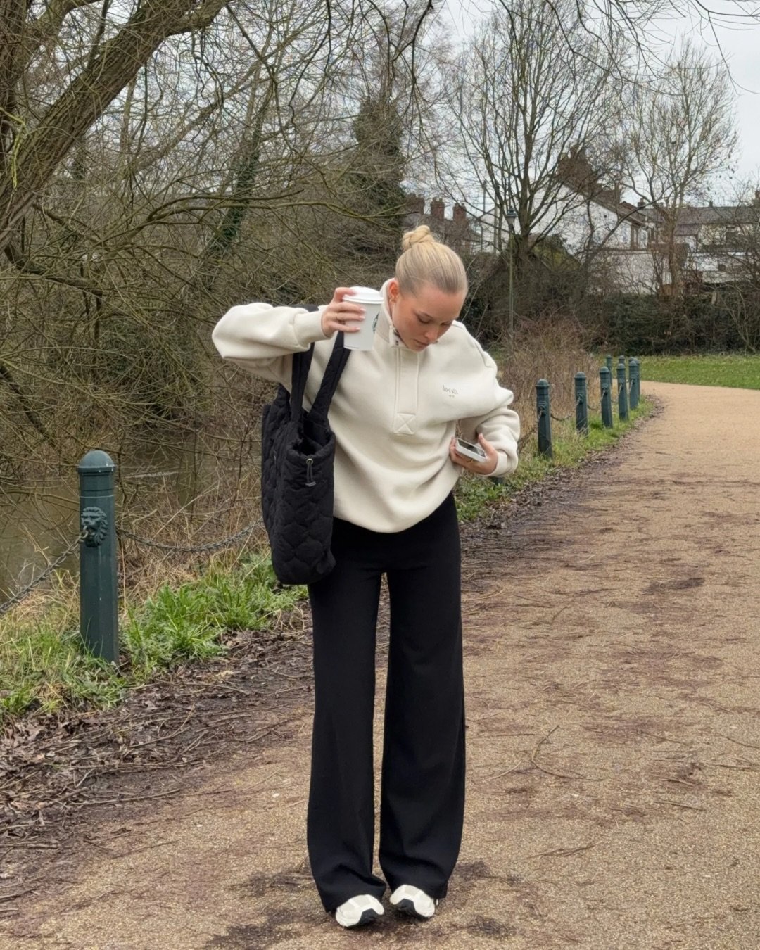 Black Relaxed Trousers with Cream Half-Zip Fleece and Quilted Tote