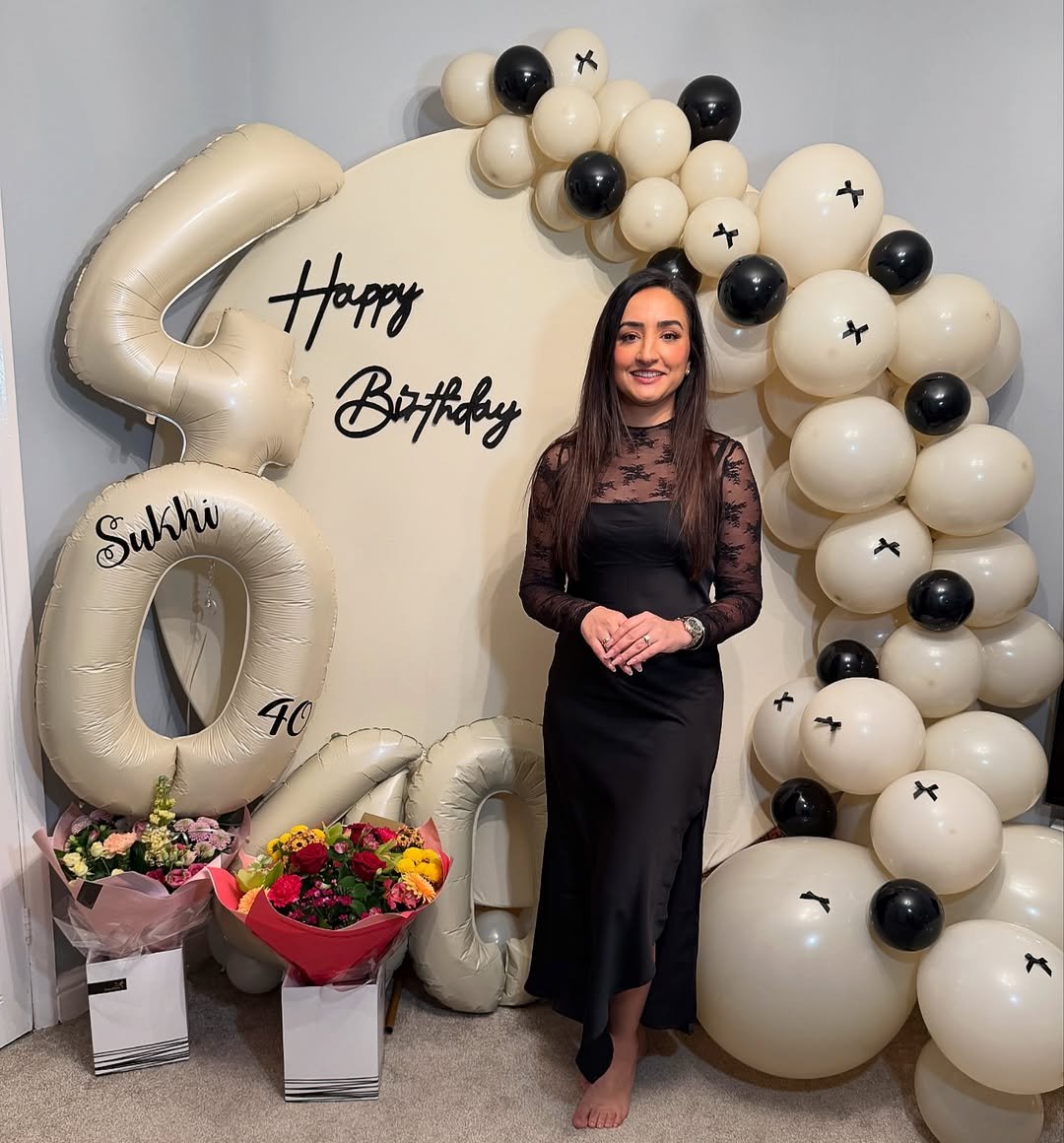 Black Satin Dress with Lace Bodice and Cream Balloon Birthday Backdrop