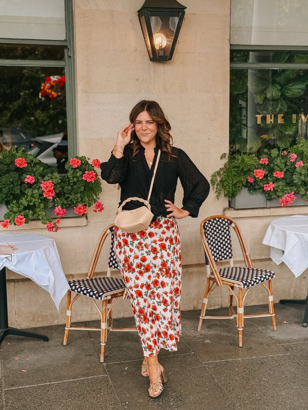 Black Swiss-Dot Blouse with Red Floral Maxi Skirt and Cream Crossbody Bag