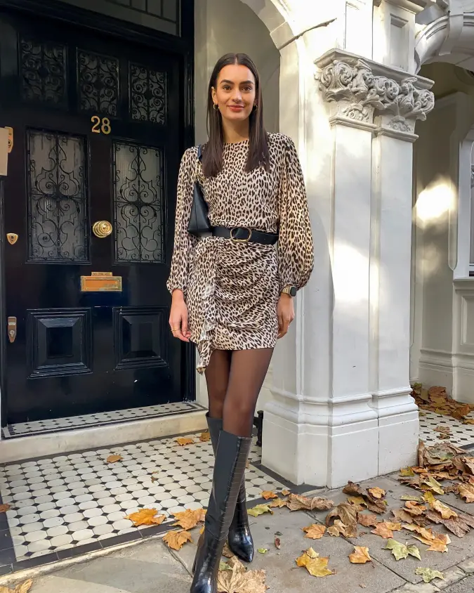 Black Turtleneck Jacket with Leopard Midi Skirt and Structured Belted Waist on Ornate Doorway Street