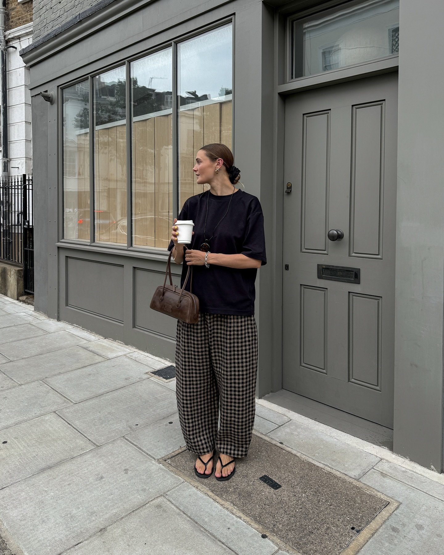 Brown Gingham Trousers with Oversized Black T-Shirt and Leather Shoulder Bag