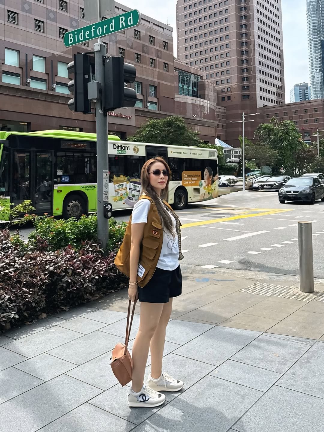 Brown Utility Vest with Graphic Tee and Black Shorts