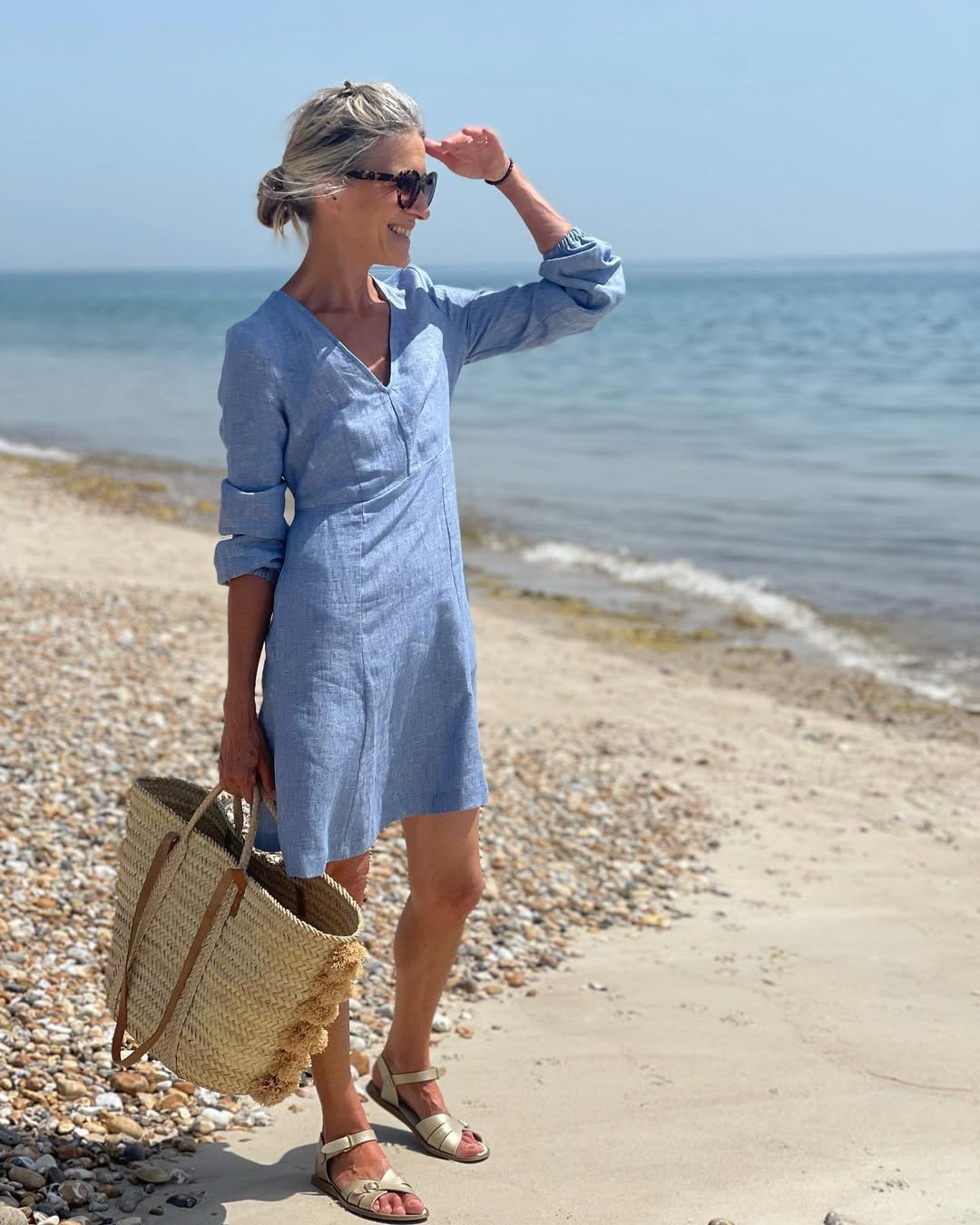Chambray V-Neck Mini Dress with a Tasseled Straw Tote and Metallic Sandals