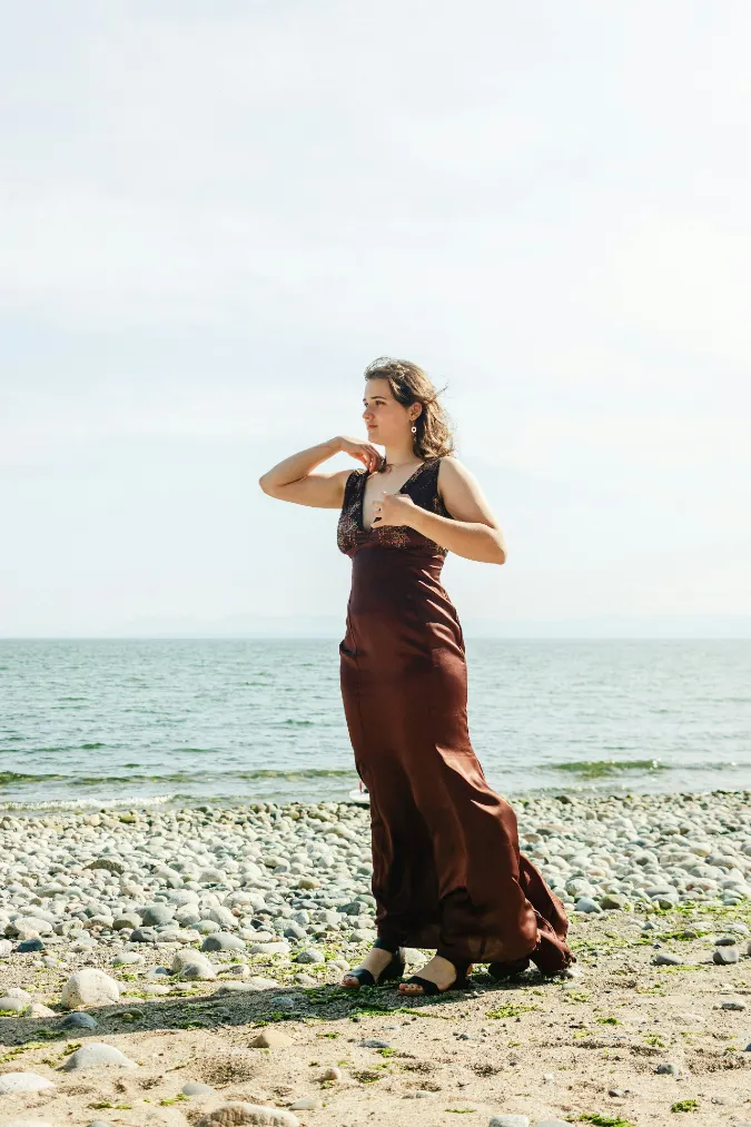 Chocolate Satin Maxi Dress on a Pebble Shore