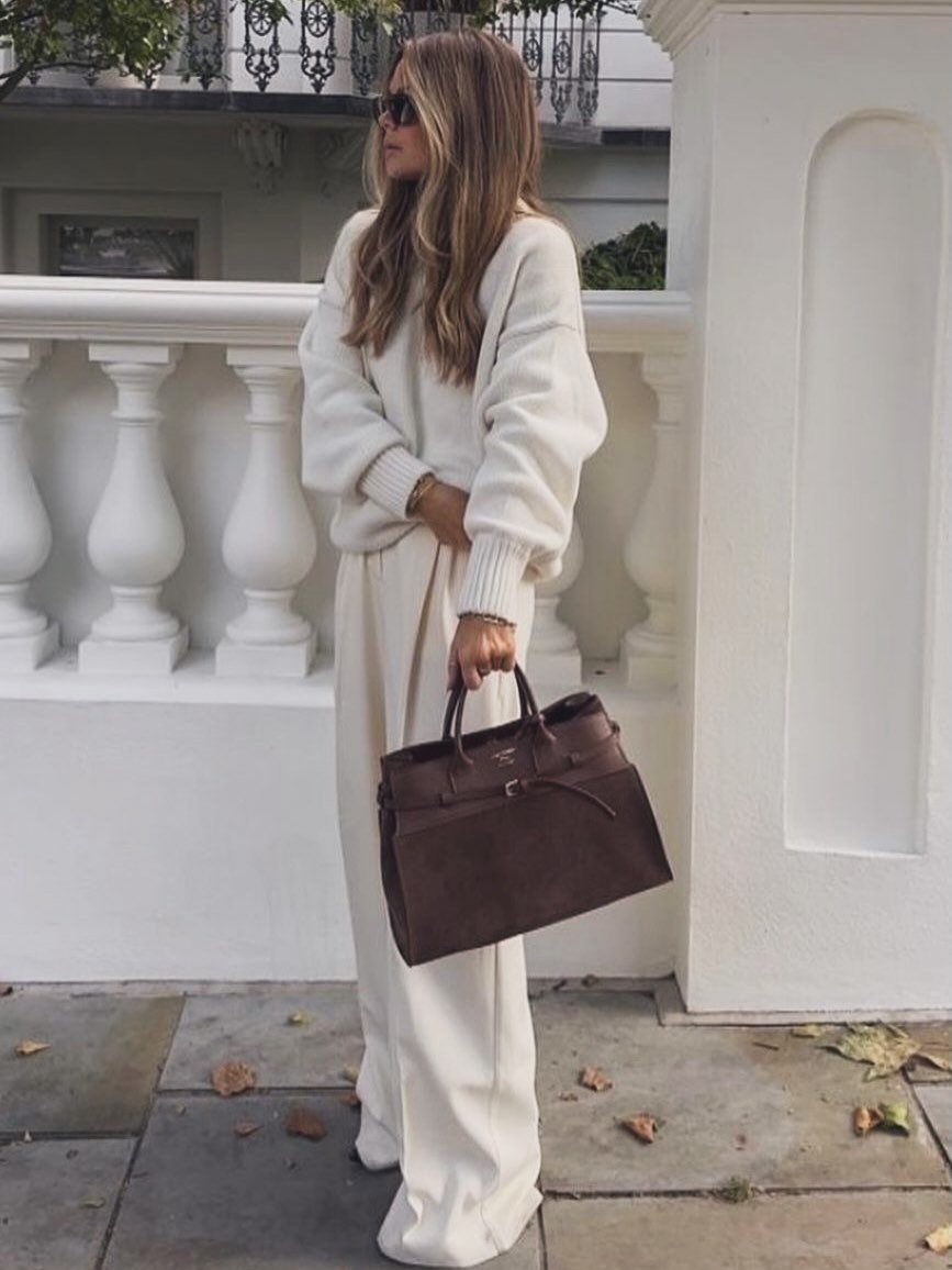 Chunky Cream Knit Sweater with Fluid High-Waisted Wide-Leg Trousers and Deep Brown Suede Handbag