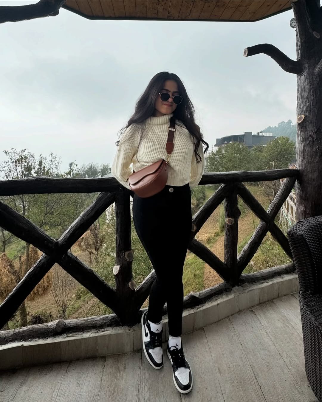 Cream Mock-Neck Cable Knit Sweater with High-Waisted Black Skinny Pants and Leather Cross-Body Bag