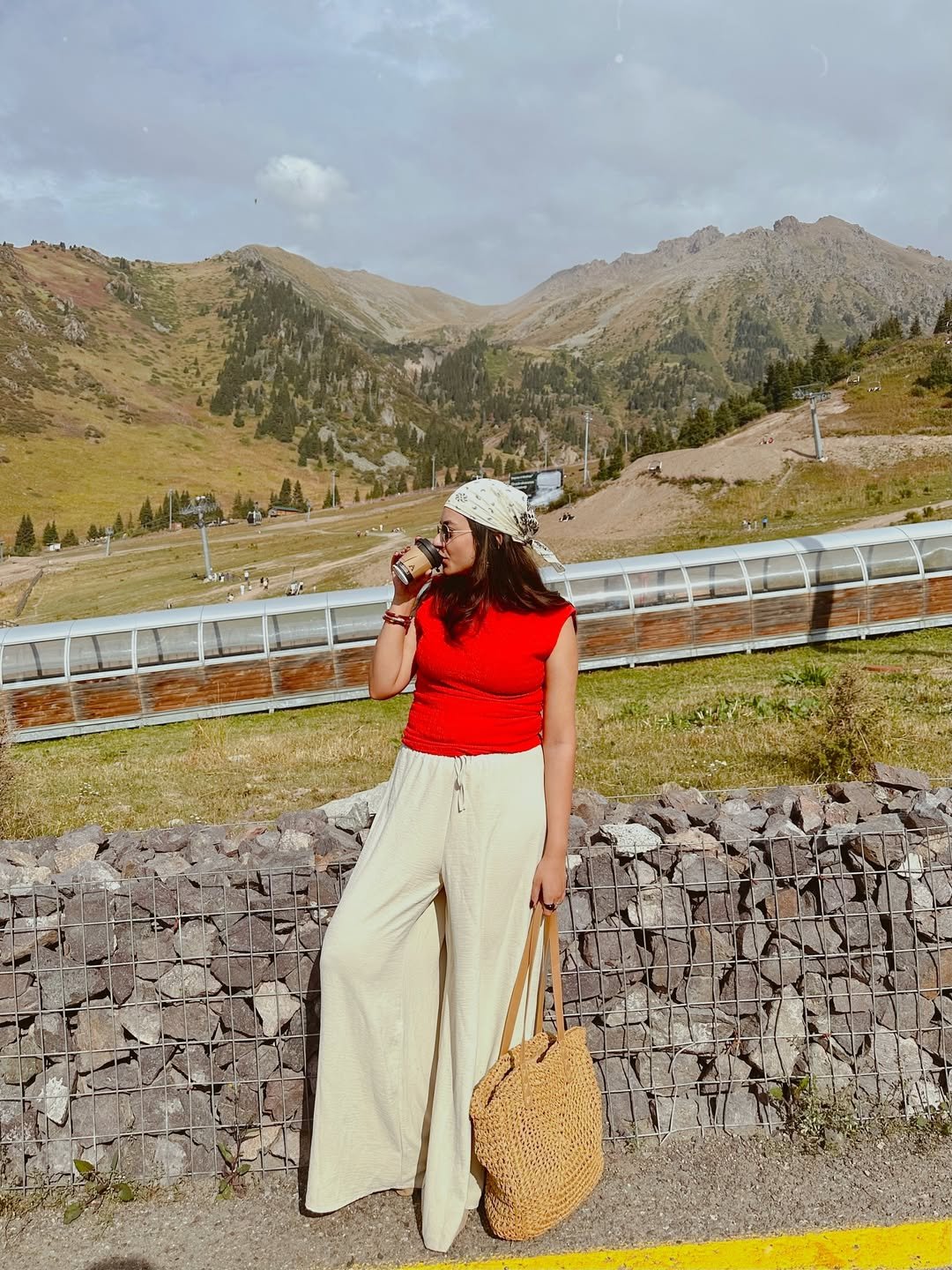 Crimson Cap-Sleeve Knit Top with Cream Wide-Leg Linen Pants and Woven Tote Bag