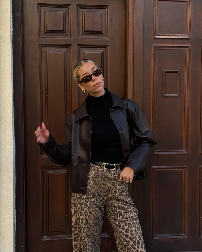 Cropped Chocolate Jacket with Leopard Trousers Against Paneled Wood Doors