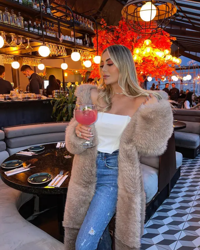 Faux Fur Coat with White Corset Top and Light Blue Jeans