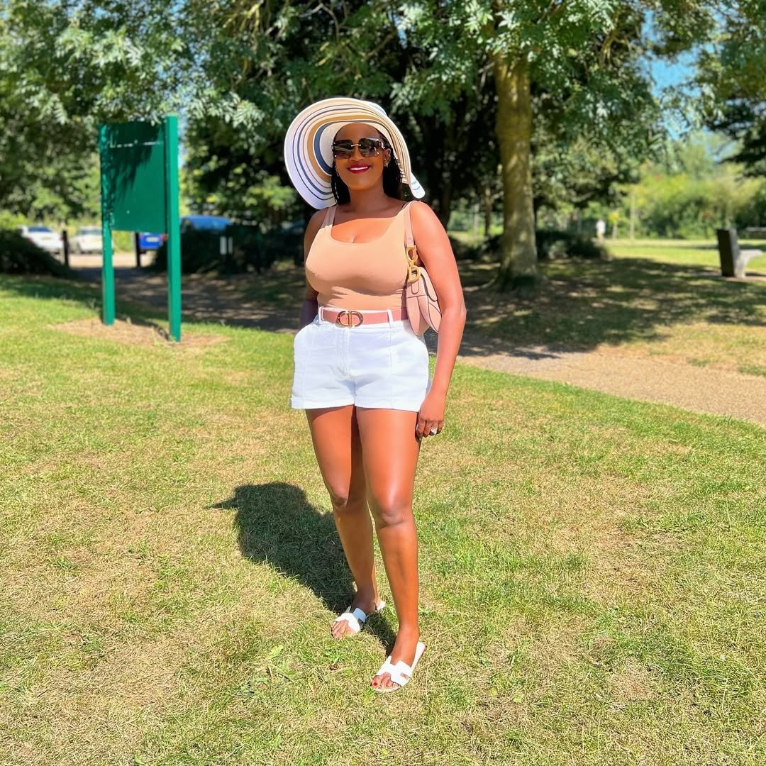 Fitted Tan Tank with Tailored White Shorts and a Striped Sun Hat