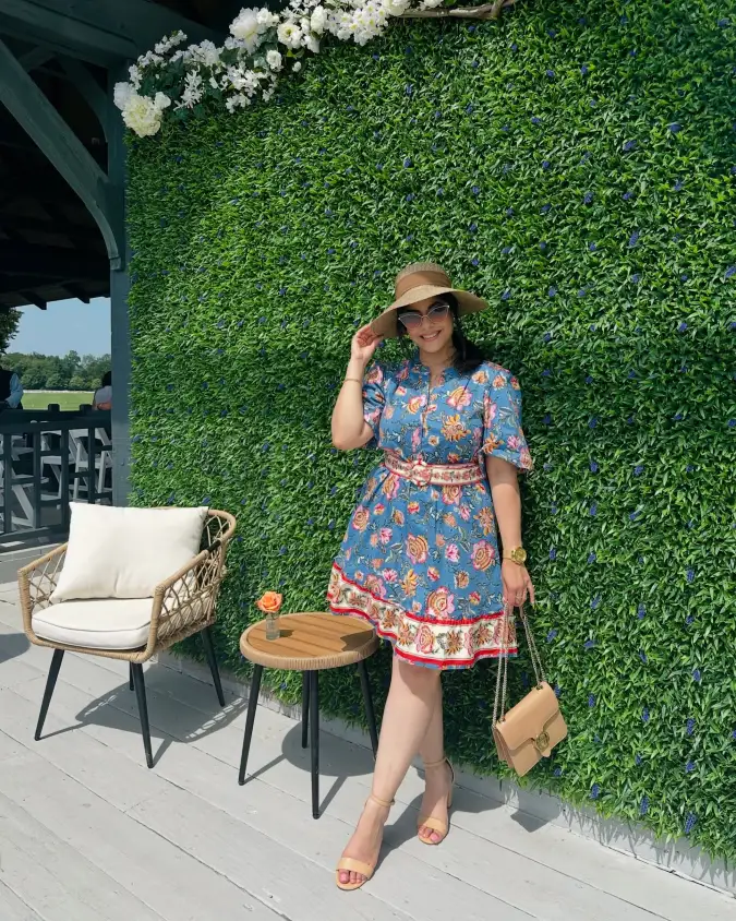  Floral Blue Mini Dress with Straw Hat by Green Hedge Wall Patio Lounge