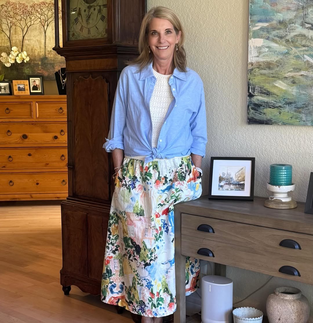 Front-Tied Blue Oxford Shirt with a Cropped Knit Vest and a Whimsical Illustrated Maxi Skirt