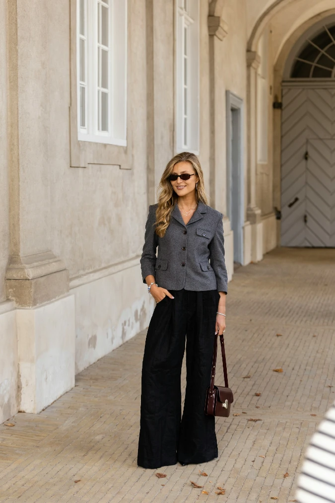 Grey Cropped Blazer with Pink Knit Layer and Black Wide-Leg Trousers for Soft Corporate Contrast