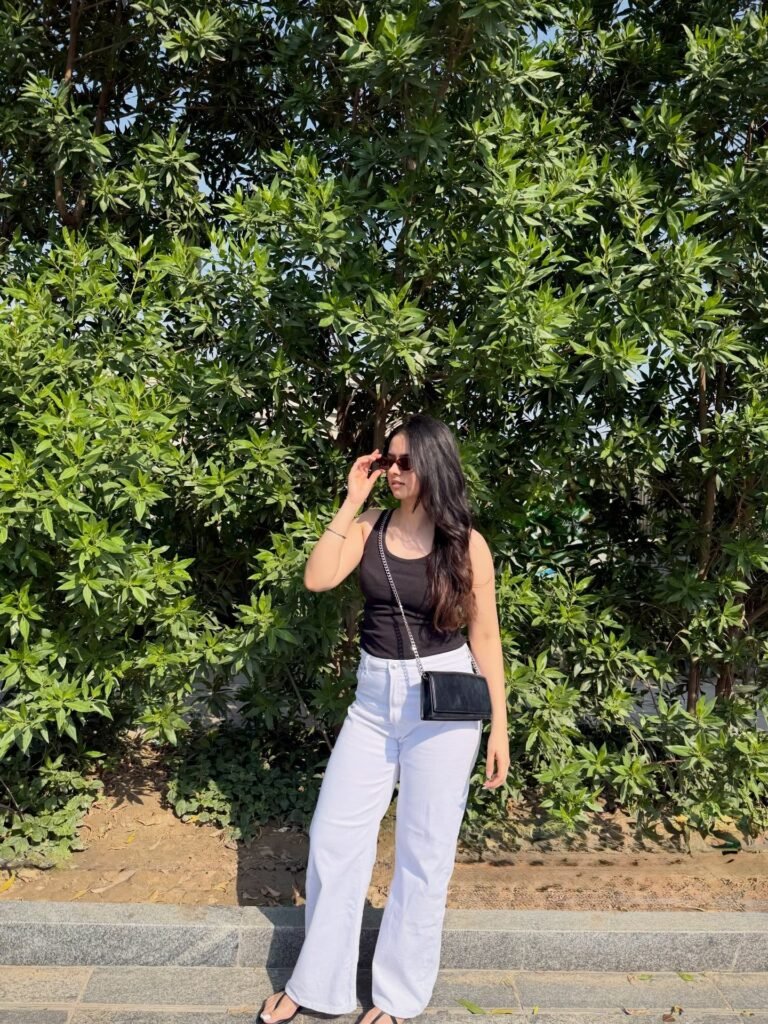 High-Waisted Wide-Leg Denim with Black Scoop-Neck Tank and Chain Crossbody Bag