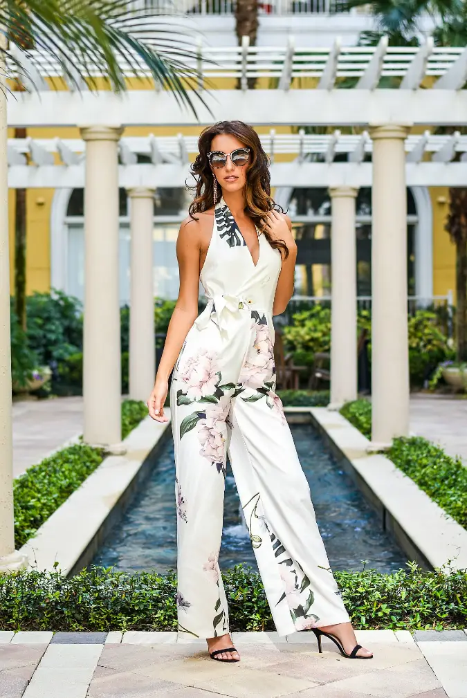 Ivory Floral Halter Jumpsuit Beside a Resort Waterway