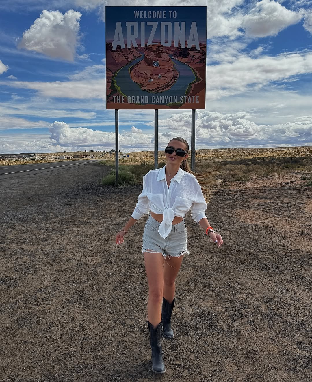 Knotted White Button-Down Shirt with Frayed Denim and Black Cowboy Boots
