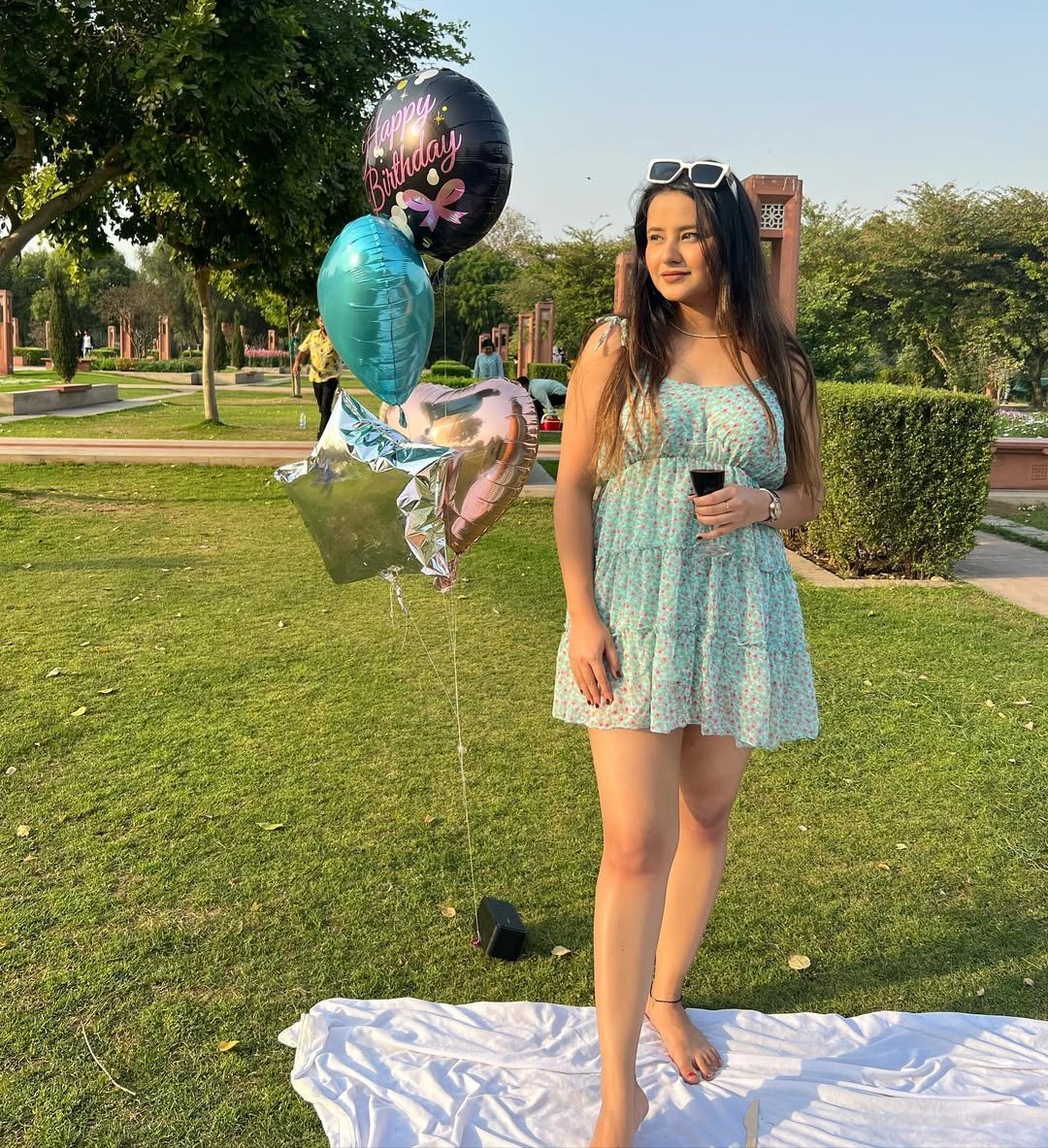 Light Blue Floral Mini Dress with Tiered Skirt and Retro Sunglasses