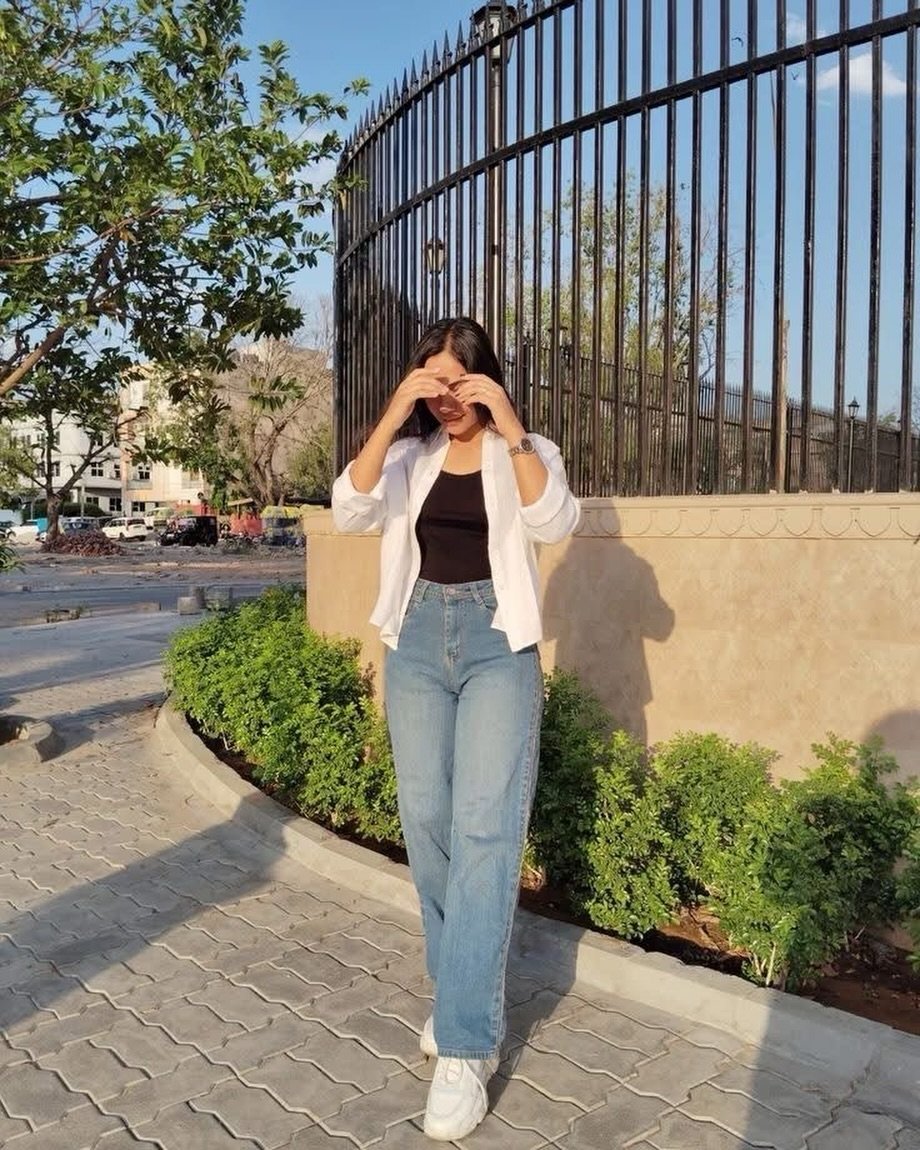 Medium-Wash Relaxed Jeans with Black Tank and Open White Shirt