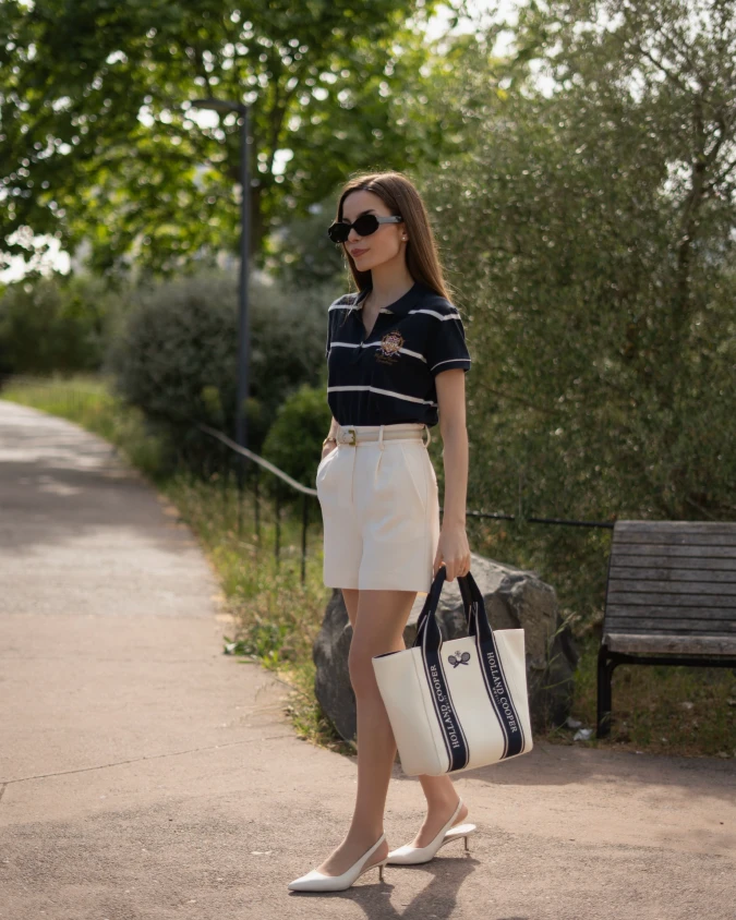Navy Striped Polo Top with Tailored White Shorts on Garden Walkway