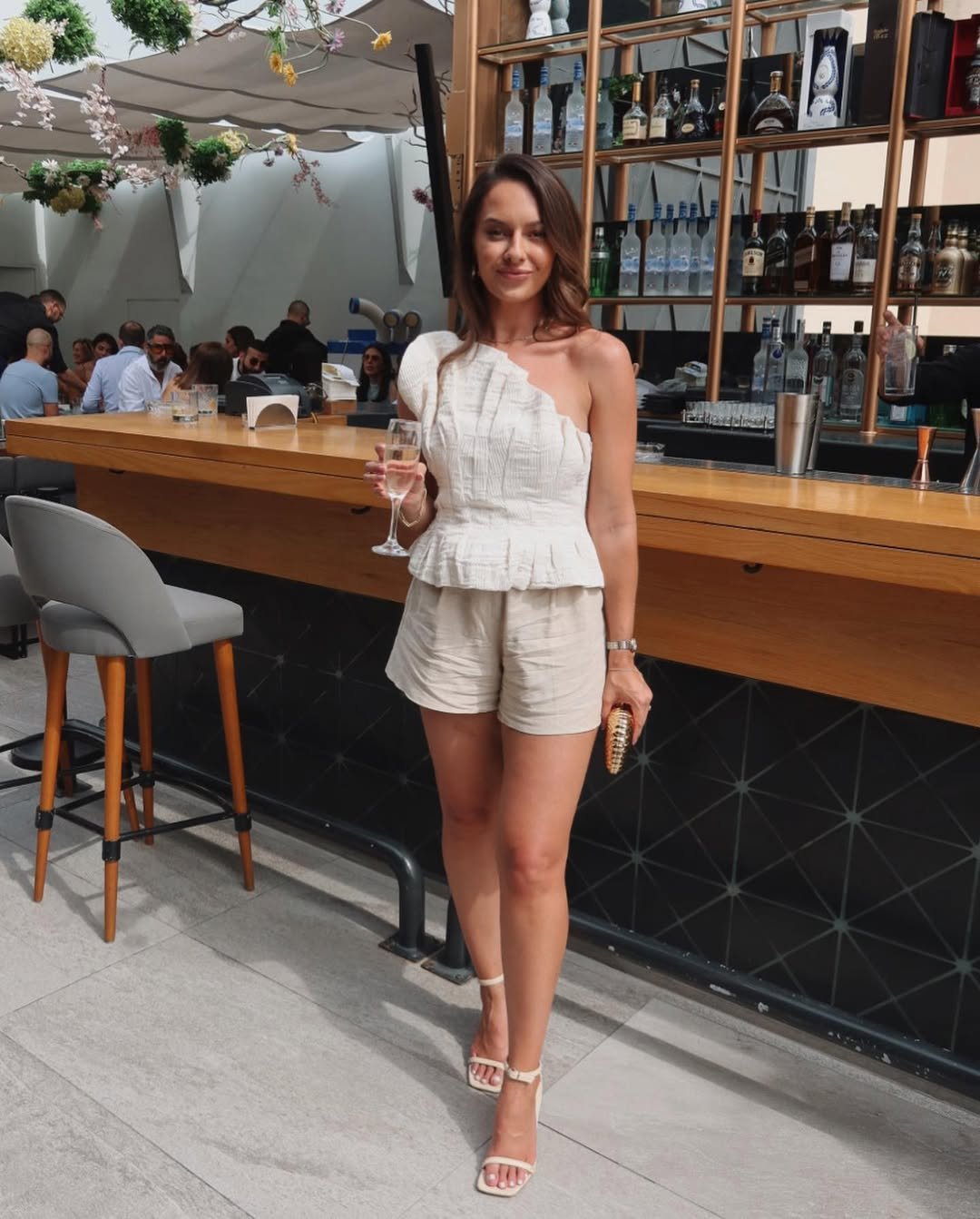 One Shoulder Beige Textured Ruffle Peplum Top and Tailored Shorts for a Country Club Brunch Outfit Idea