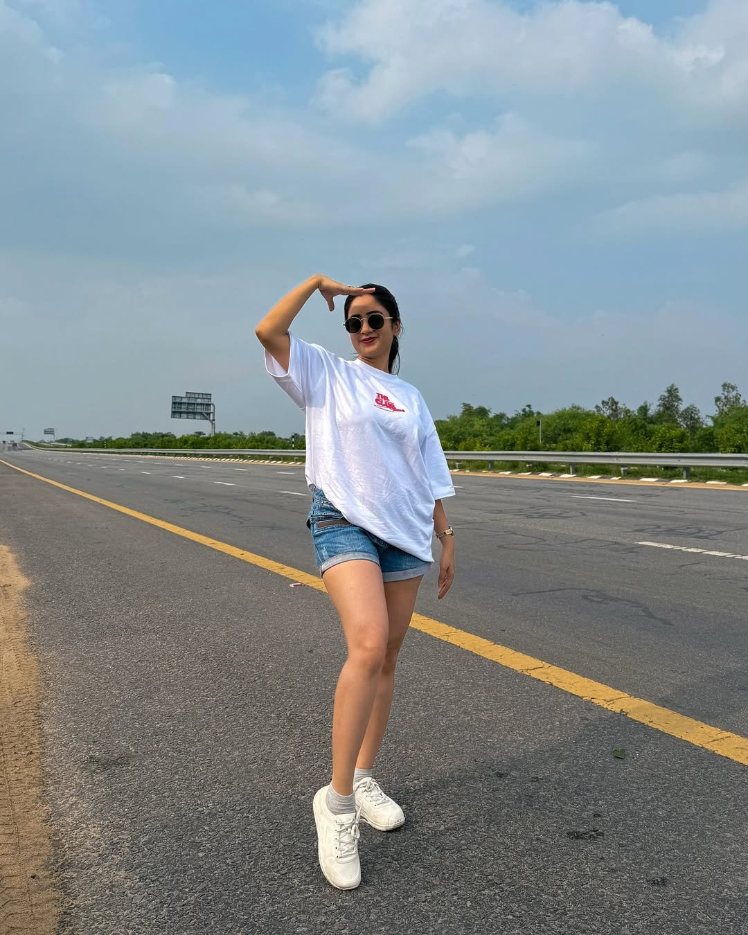 Oversized White T-Shirt with Cuffed Denim Shorts and Chunky Sneakers