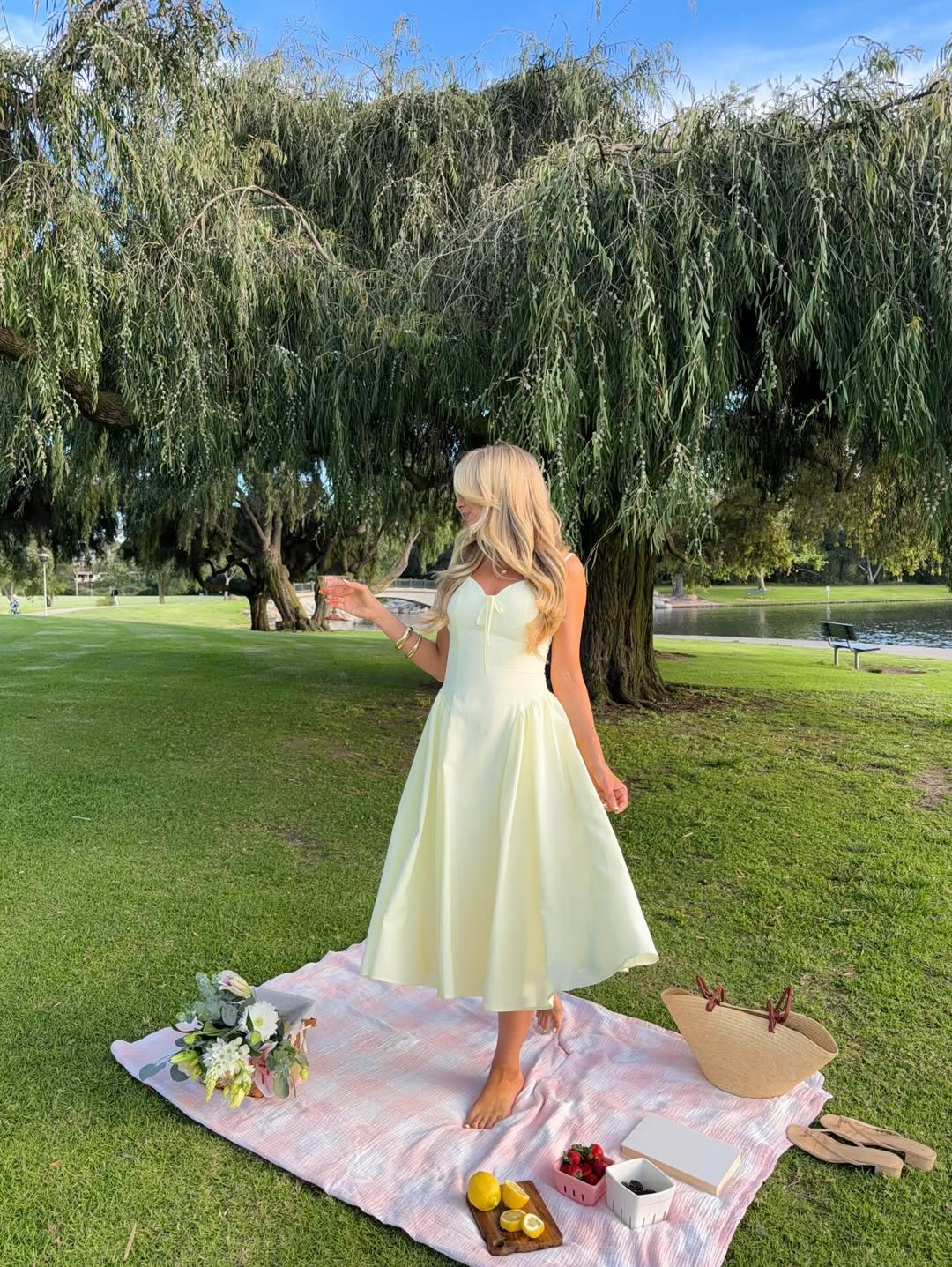 Pale Yellow Flared Midi Dress with a Woven Straw Tote