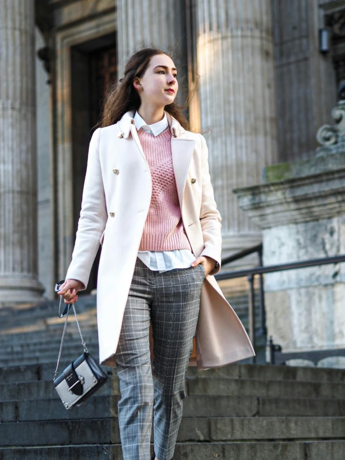 Pink Knit Sweater with White Coat and Grey Plaid Trousers for Soft Professional Street Style