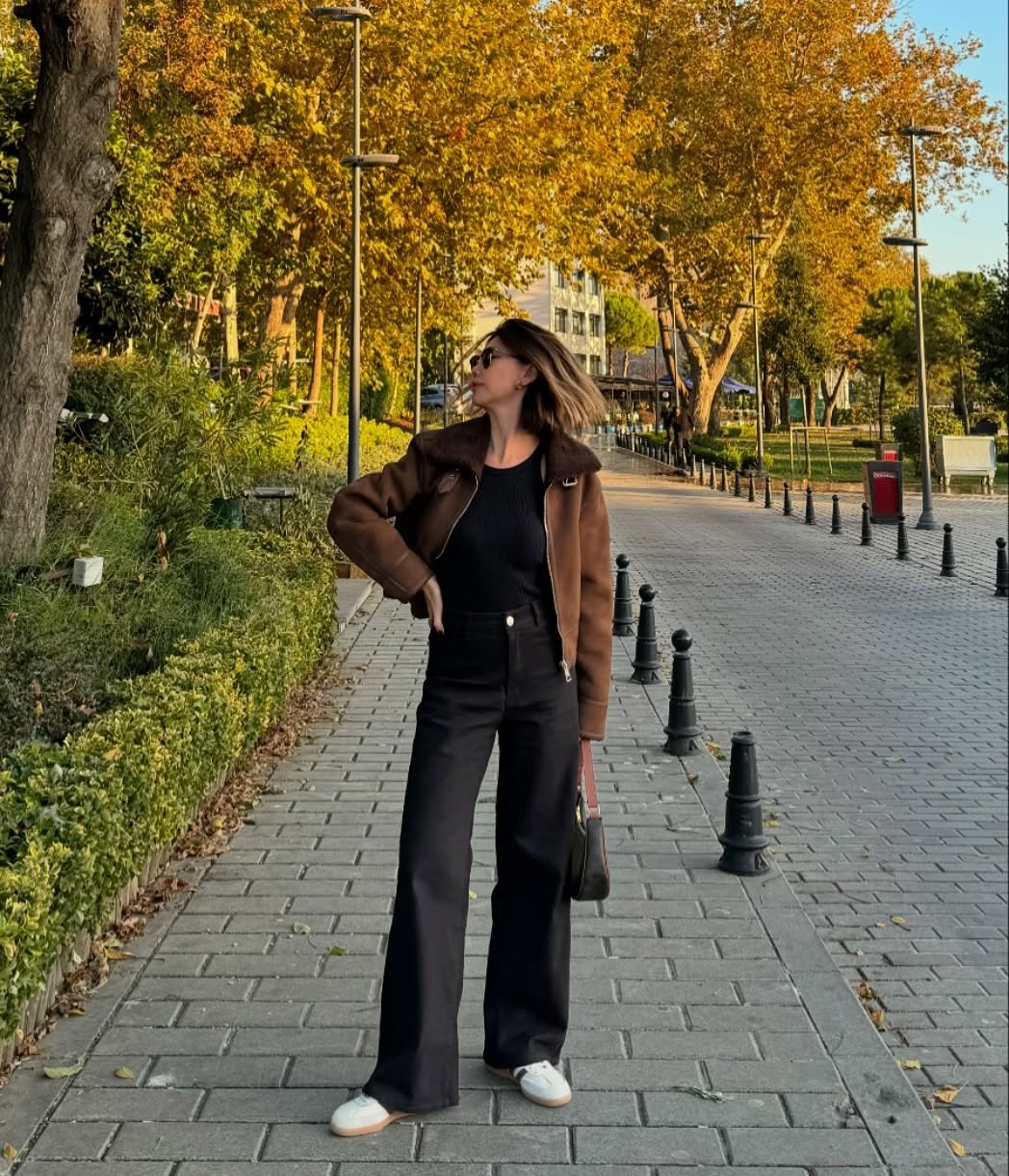 Pitch Black Denim Trousers with Brown Shearling Jacket and White Sneakers