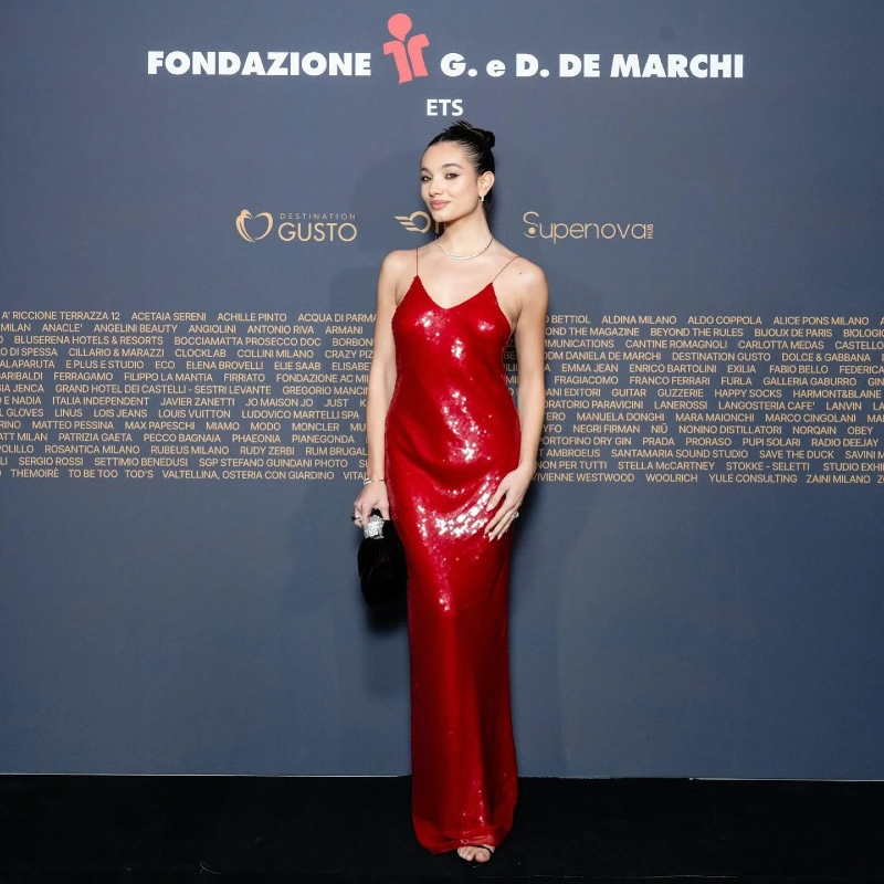 Sculpted Red Sequin Column Gown Against Step-and-Repeat Backdrop