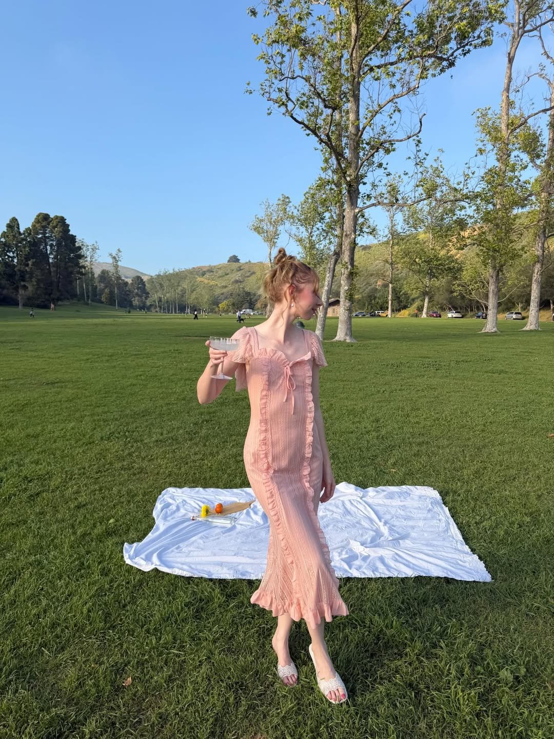 Smocked Pink Midi Dress with Ruffle Detailing and White Lace Sandals