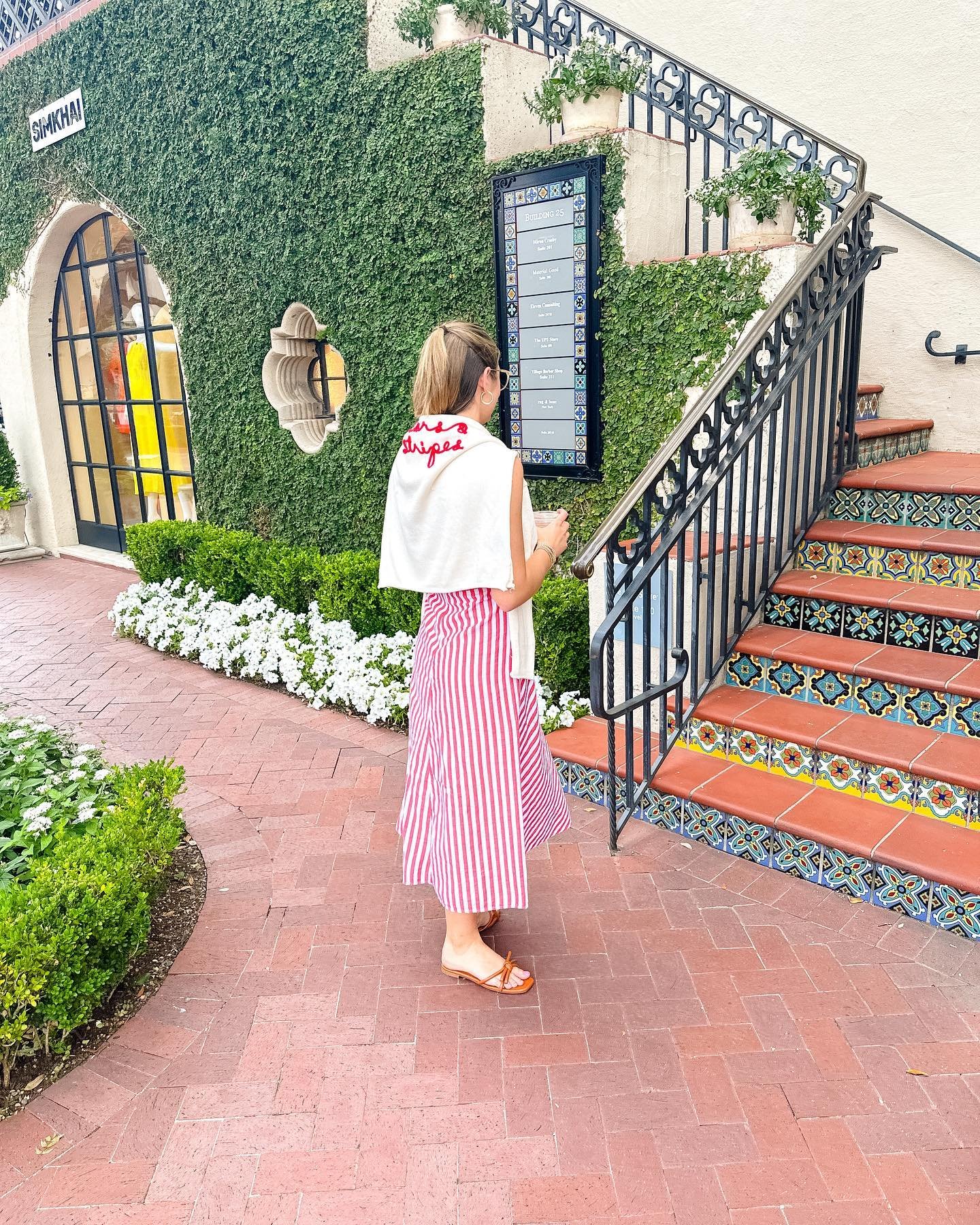 Striped Midi Skirt with Embroidered Sweater Draped Over Shoulders