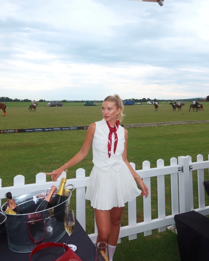 Tailored White Vest with Red Silk Scarf and Pleated Mini Skirt at Polo Fence Bar