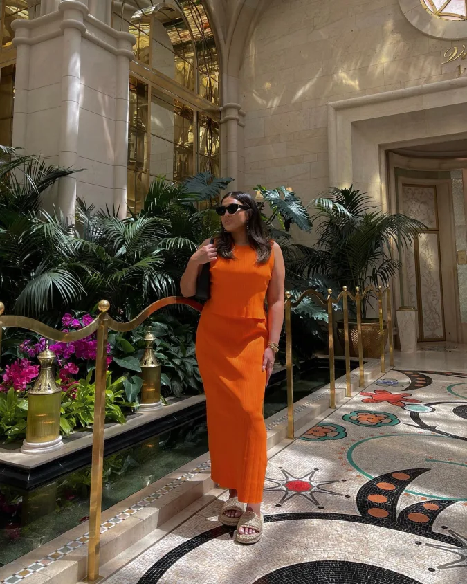 Tangerine Ribbed Midi Set in a Palm Filled Atrium
