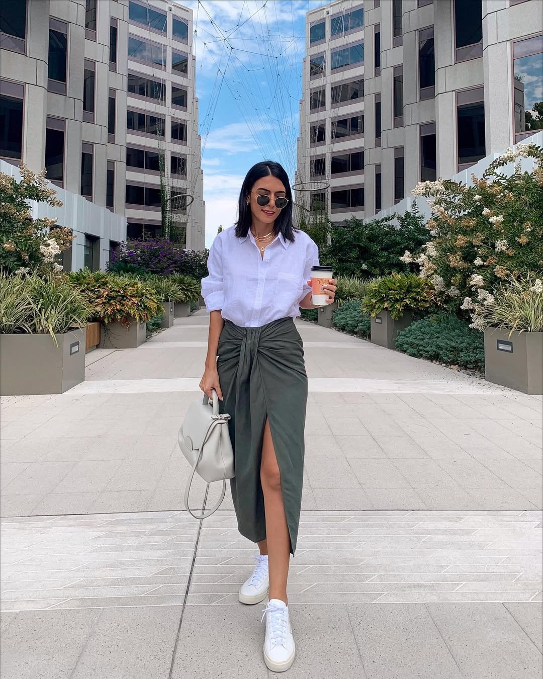 White Button-Down Shirt with Knotted Olive Midi Skirt and White Sneakers