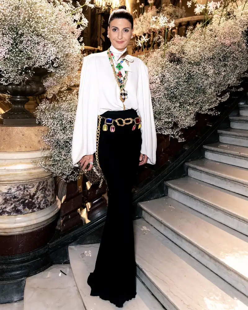 White Cape Blouse with Jewel Chain Belt and Black Column Skirt on Grand Staircase