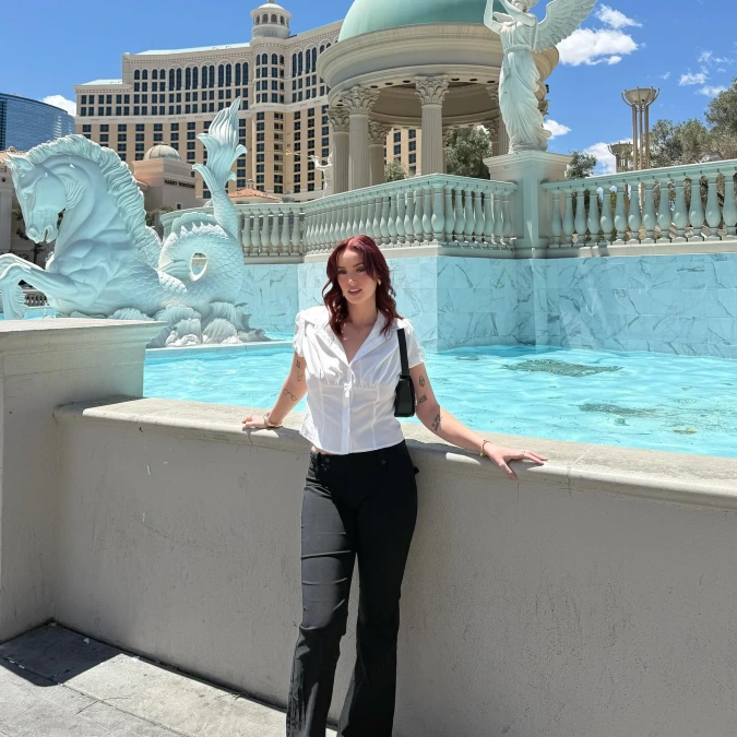 White Puff Sleeve Blouse with Black Flare Pants by the Aqua Fountain