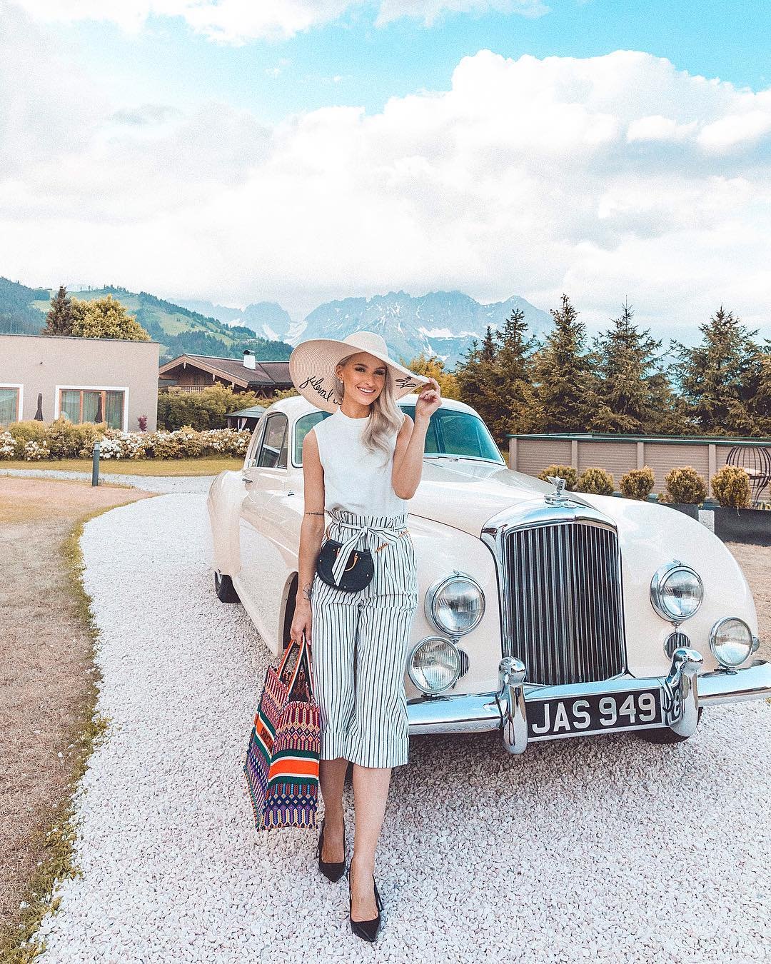 White Sleeveless Top with Striped Tie-Waist Culottes and Wide-Brimmed Hat
